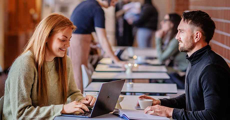 Two students studying together at a café.